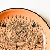 Peach Ceramic plate with a floral design on an white background