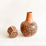 Peach Ceramic carafe with floral patterns on a white background