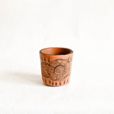 Peach Ceramic cup with floral design on a white background