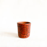 Ceramic cup with floral design on a white background