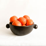 Ceramic bowl with oranges on a white background