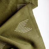 Olive Green woven cotton table runner with white geometric patterns on a white background