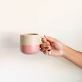 Pink and vanilla two-tone ceramic mug with a matte finish, rounded shape, and curved handle.