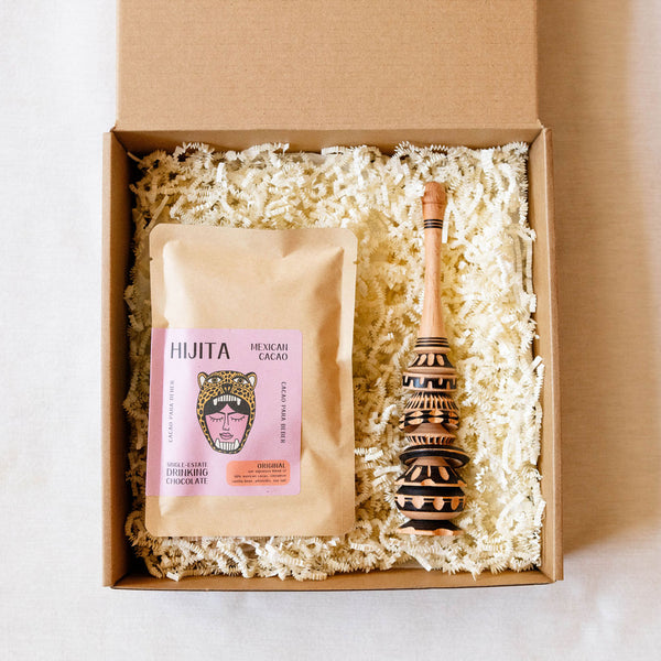 Hijita Mexican Cacao packaging with a chocolate bar and wooden muddler molinillo in a gift box