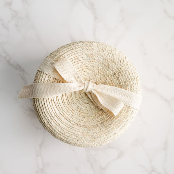 Handcrafted, natural Palm gift basket with cotton twill ribbon. Give the gift of self-care, while doing good for the planet. The Poderosa Gift basket offers a curated selection of best selling, low-waste products from Latina-owned brands, exclusively available at VOLVERde. Includes an agave body sponge that provides gentle, plant-based exfoliation, an Amahu handcrafted soap bar and Sanara Skincare Rosehip Seed Body Oil in handcrafted, artisanal gift basket. Thoughtful, sustainable gifting made easy.