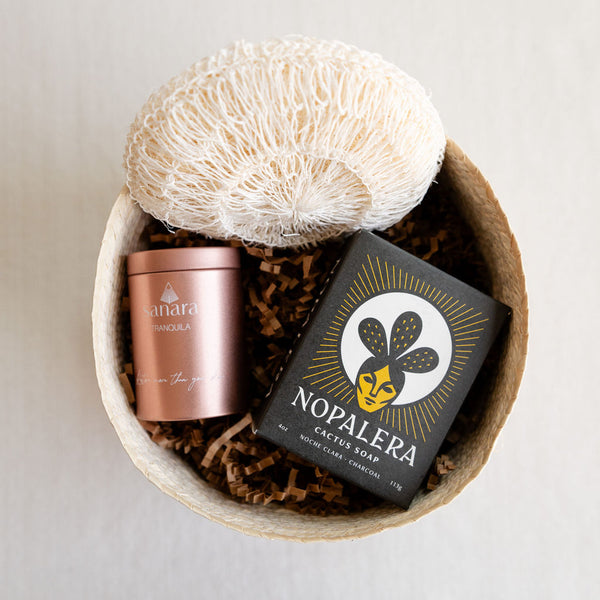 Sustainable, artisanal palm gift basket featuring three Latina-owned brands: Nopalera, Sanara Skincare and an Agave Body Sponge
