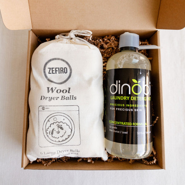 The perfect gift for a new baby. This sustainable, plant-based laundry kit for sensitive skin features Dinobi natural laundry made for precious skin and a set of 6 large wool dryer balls.