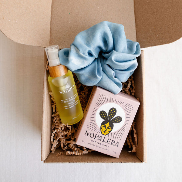 Nopalera Cactus Soap, Sanara Skincare Chilean Rosehip Seed Body Oil, Gu Shu Silk Scrunchie in light blue. treat yourself or a loved one to plant-based luxury with this trio of low-waste bath and body goods, all sourced exclusively from Latina-owned brands. This is the perfect 'treat yourself' gift for yourself or an eco-conscious friend that likes to make an impact.