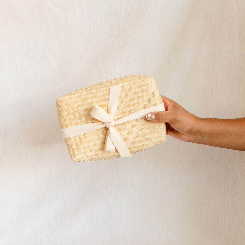 Handwoven Palm Lidded Basket with natural palm leaf texture. The basket features a tightly woven design with a matching lid, showcasing artisanal craftsmanship from Mexico. Perfect for eco-friendly storage, the basket exudes a minimalist and earthy aesthetic.