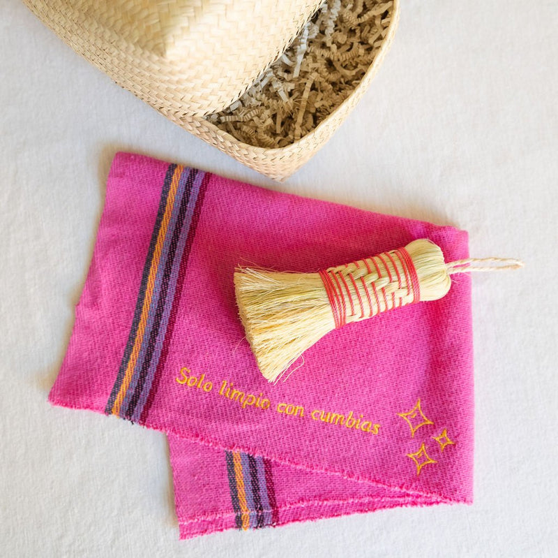 "Pink Rosa Mexicano Cleaning Rituals Gift Basket featuring a Pink Jerga cloth, Pink Escobeta brush, and a large, handwoven Palm Basket. The set combines vibrant pink accents with natural palm materials, creating a beautiful and practical collection for cleaning rituals.