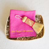 Pink Rosa Mexicano Cleaning Rituals Gift Basket featuring a Pink Jerga cloth, Pink Escobeta brush, and a large, handwoven Palm Basket. The set combines vibrant pink accents with natural palm materials, creating a beautiful and practical collection for cleaning rituals.