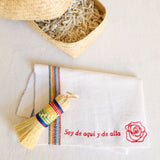 Nube Mexicano Cleaning Rituals Gift Basket, featuring a soft white Jerga cloth, a vibrant rainbow-colored Escobeta brush, and a large handwoven palm basket. The set combines traditional Mexican cleaning essentials, beautifully arranged for a practical and aesthetically pleasing presentation