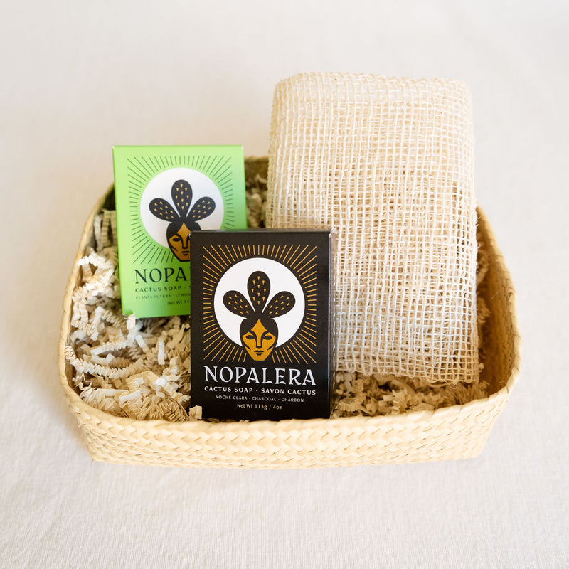 Gift basket for bathing rituals featuring a Nopalera Planta Futura Soap Bar, Nopalera Noche Clara Soap Bar, agave ayate washcloth, and a handcrafted palm basket. Perfect for self-care routines, with natural, artisanal items for a luxurious bathing experience.