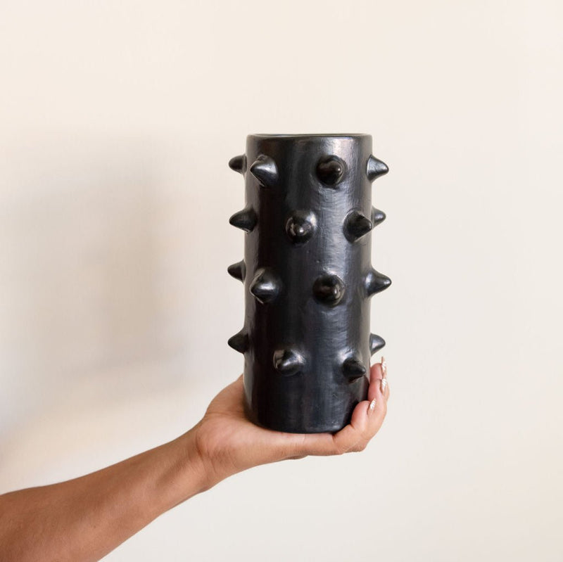 Hand holding a handcrafted Spiked Black Clay Vase made from authentic Mexican black clay (barro negro), featuring a bold, modern spiked design. Perfect for contemporary home decor or as a unique artisanal statement piece.