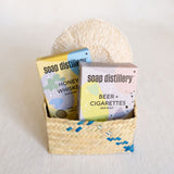 Gift set featuring a Lavender and Honey Soap Bar Duo and an Agave Body Sponge, beautifully presented for a natural and soothing bathing experience. The soap bars showcase a gentle lavender and honey scent, paired with a textured agave sponge for exfoliation, all designed to create a relaxing self-care ritual. All nestled in a palm gift basket.