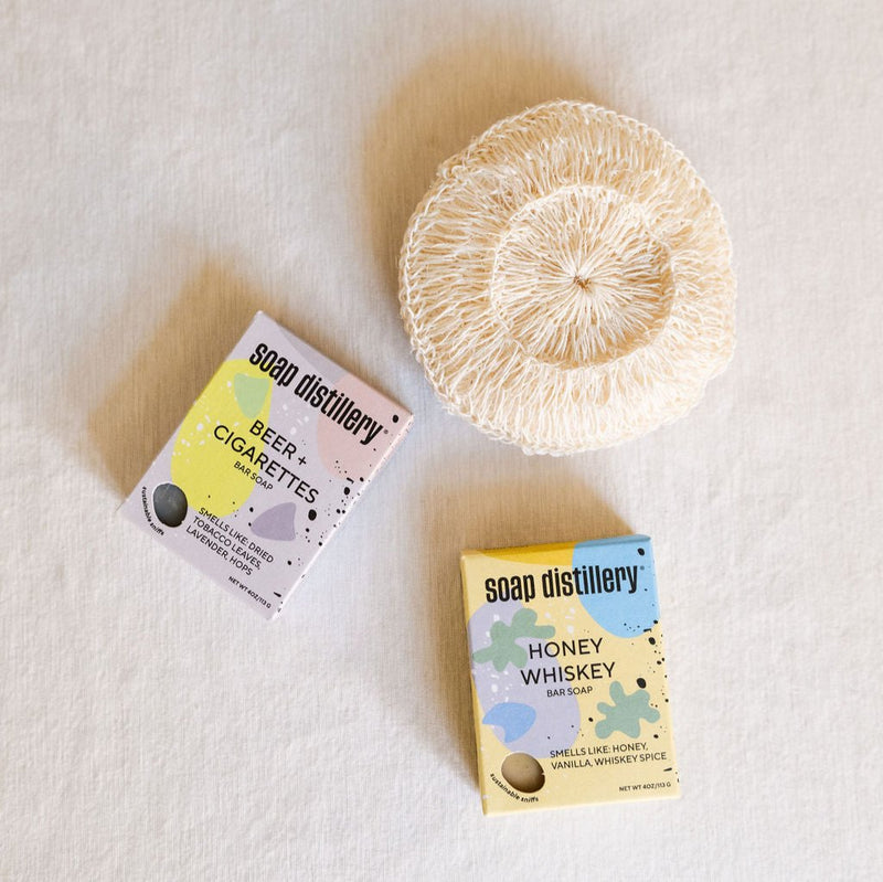 Gift set featuring a Lavender and Honey Soap Bar Duo and an Agave Body Sponge, beautifully presented for a natural and soothing bathing experience. The soap bars showcase a gentle lavender and honey scent, paired with a textured agave sponge for exfoliation, all designed to create a relaxing self-care ritual