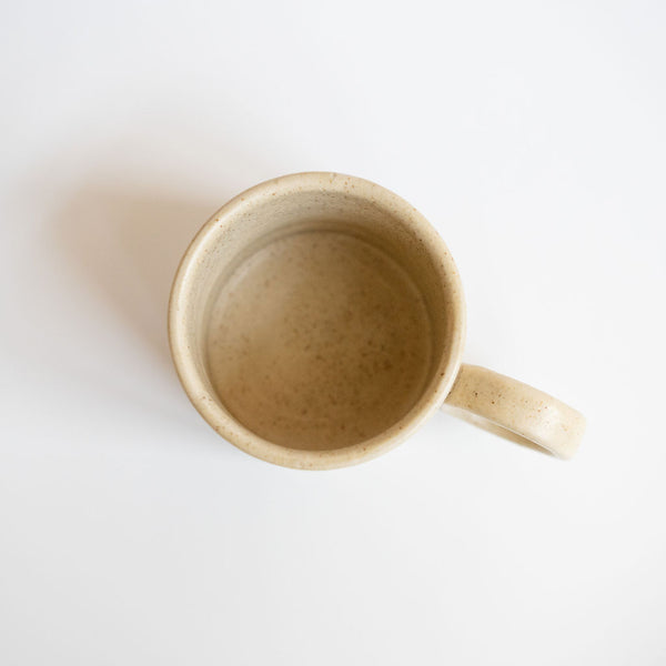 Vainilla Creme Ceramic Mug Top View with a soft, off-white finish and a smooth, matte texture. The mug features a simple, elegant design with a comfortable handle, perfect for enjoying a cozy cup of coffee or tea. The neutral tone complements any kitchen or table setting.