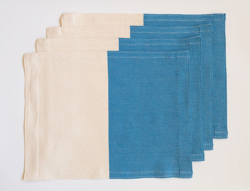 Set of four handwoven cotton placemat on a pedal loom in color block design with half Azure Blue and half neutral