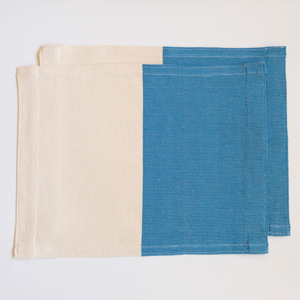 Set of two handwoven cotton placemat on a pedal loom in color block design with half Azure Blue and half neutral