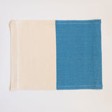 Handwoven cotton placemat on a pedal loom in color block design with half Azure Blue and half neutral