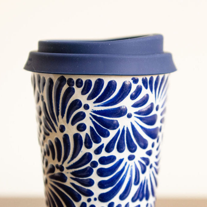 Navy Blue Ceramic Talavera Tumbler with hand painted navy blue detail on a white background with Navy Blue lid held