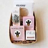 Basket with Nopalera, and Sanara skincare products on a white background. Includes Ayate washcloth, body oil, lotion bar, and soap bars