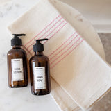 This is a trio of sustainable everyday essentials, ethically made using premium ingredients. Includes a woven hand towel made by expert weavers in small batches, coupled with spa-quality hand soap and body lotion made using herbs grown on an organic family farm. This is the perfect touch for your bathroom or kitchen. 