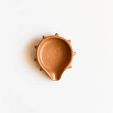 Terracotta ceramic soap dish with a unique design on a white background