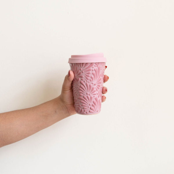 Pink Talavera Ceramic Coffee Tumbler with silicone pink lid held by a hand. Featuring intricate, traditional Mexican ceramics in bold, fade-resistant colors. 