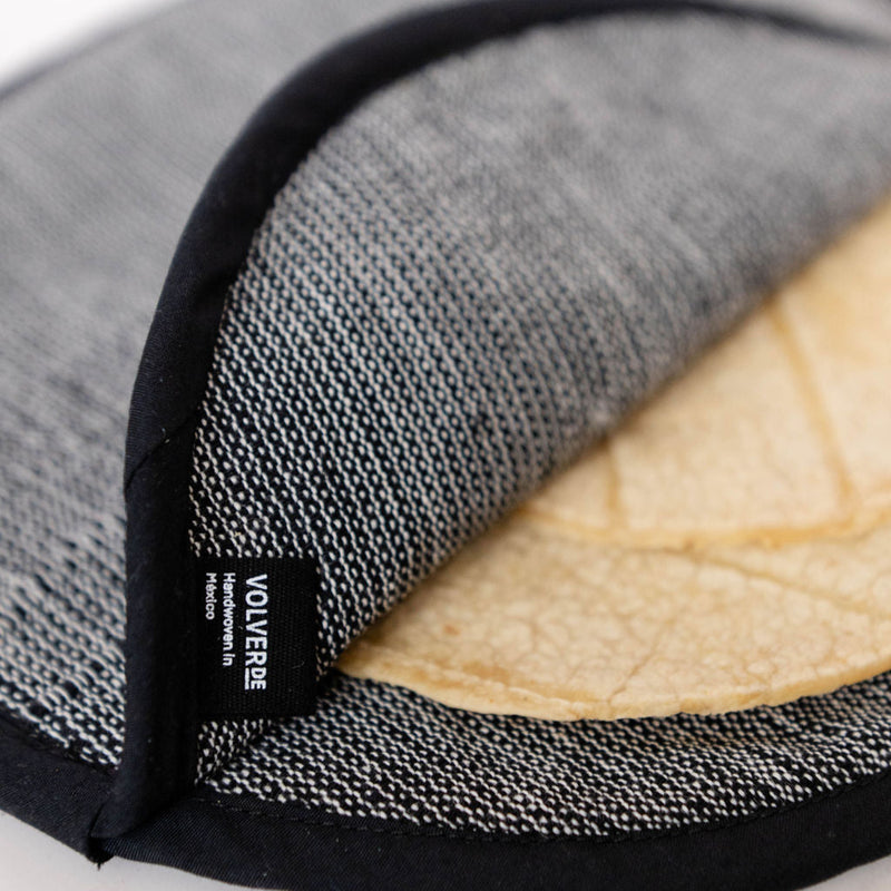 Black and white cotton cloth bag to keep tortillas warm on a white background