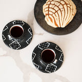 Black and White geometric expresso sets cups and saucers on white marble background and a white concha
