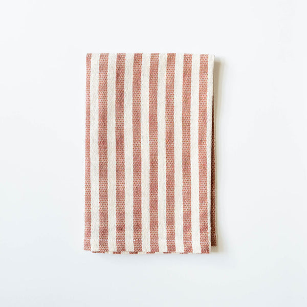 Striped fabric with cinnamon brown and white pattern on a white background