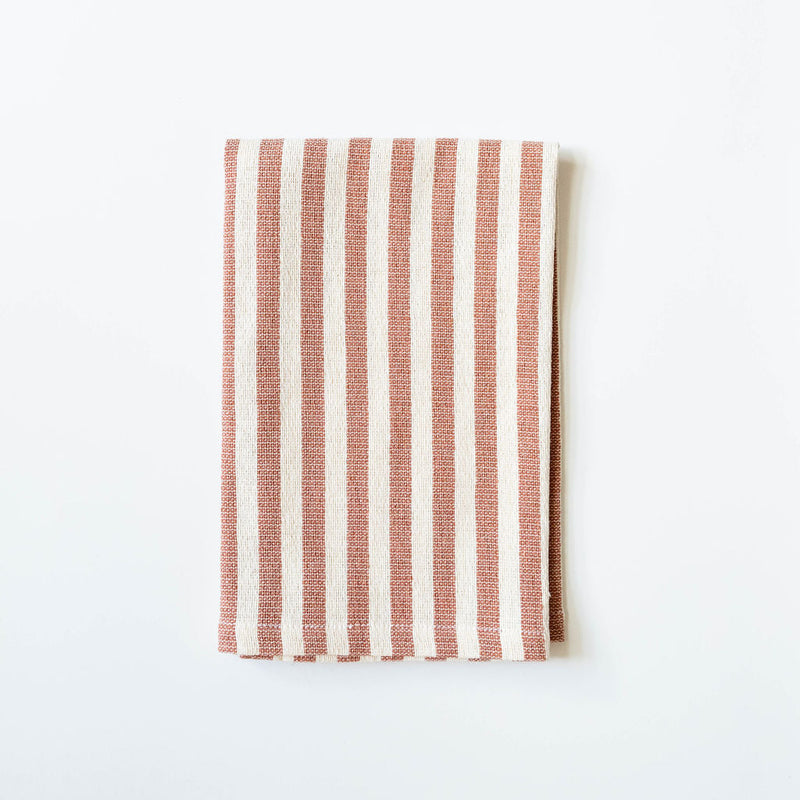 Striped fabric with cinnamon brown and white pattern on a white background