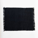 Black fringed napkin on a white background