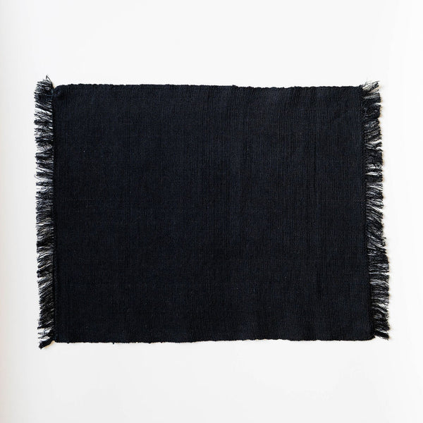 Black fringed napkin on a white background