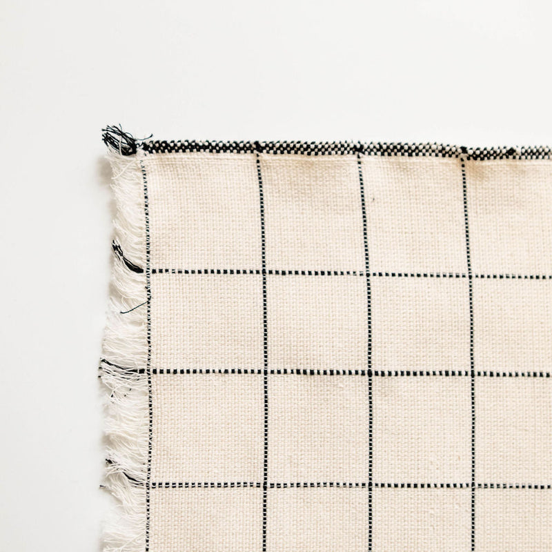 Plaid napkin with black and white pattern on a white background