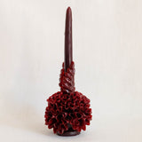 Burgundy Oaxaca Taper Beeswax Candle with floral base on a light beige background