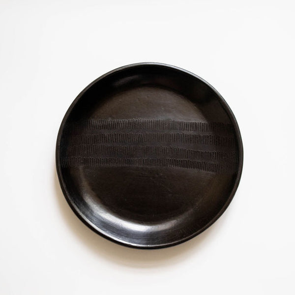 Black ceramic plate on a white background