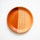 Ceramic plate with a textured design on a white background