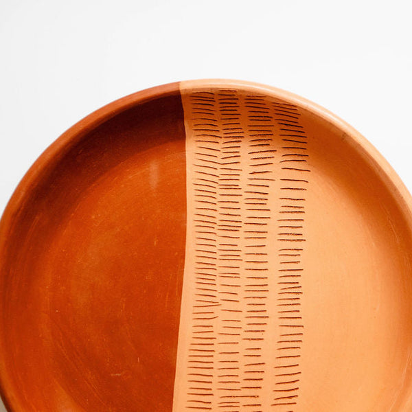 Ceramic plate with a textured design on a white background