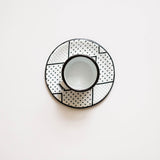 Expresso cup and saucer with geometric pattern on a white background