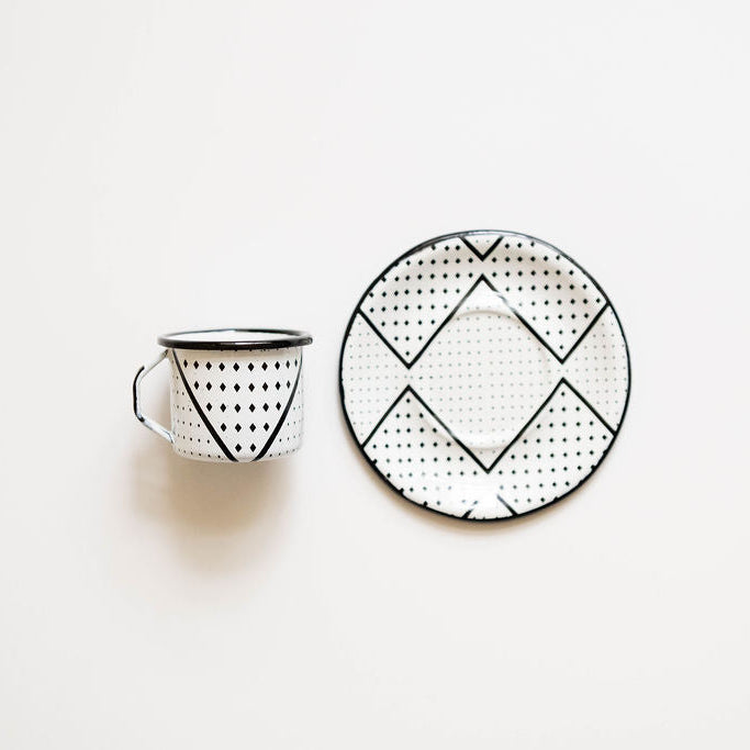 Black and white patterned expresso mug and plate on a light beige background