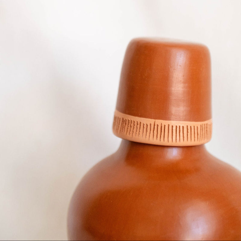Brown bottle with a cap on a light beige background