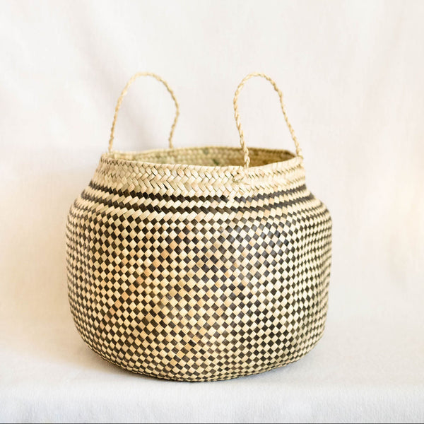 Woven basket with handles on a light background