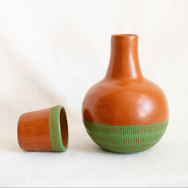 ceramic vase with green accents on a white background