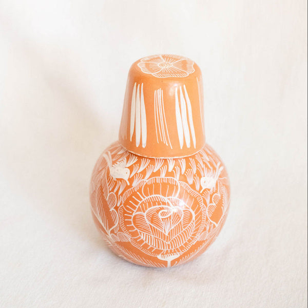 Decorative vase with white floral patterns on a light beige background