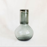 Clear Black recycled glass carafe with cup as a lid on a white background