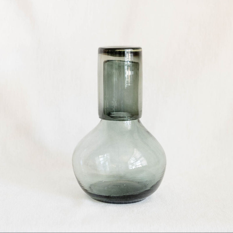 Clear Black recycled glass carafe with cup as a lid on a white background