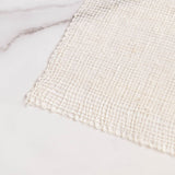 Closeup of Woven Agave Fiber Ayate Washcloth on a marble surface