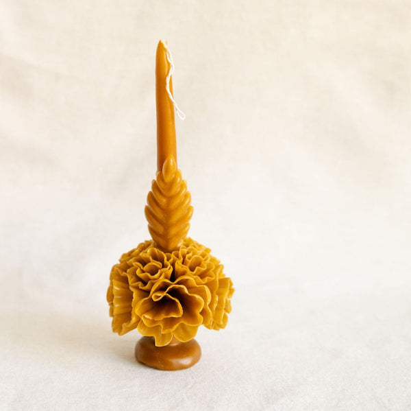 A stunning self-standing artisanal Oaxacan beeswax candle in rich amber gold, intricately hand-carved with traditional floral patterns. This eco-friendly, long-lasting candle brings a touch of Mexican craftsmanship and sustainability to any home décor, perfect for those seeking authentic, handmade products.